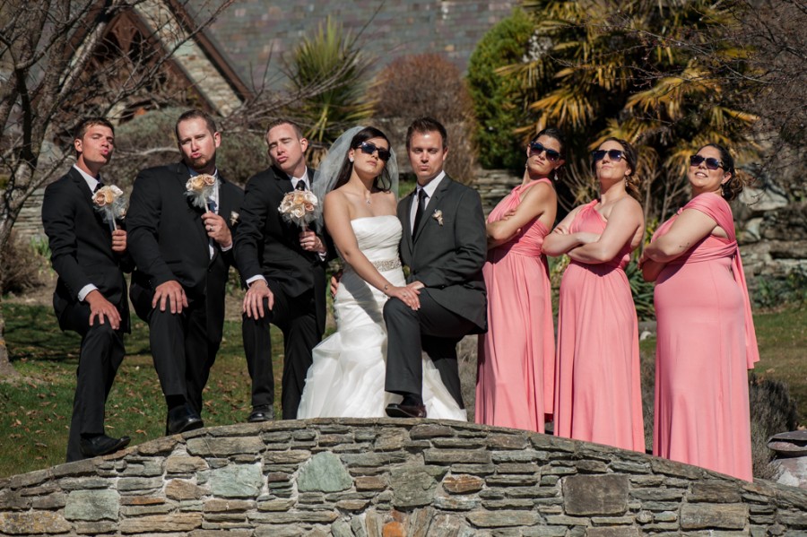 Bridal party looking cool on a bridge at Chapel by the lake, Queenstown