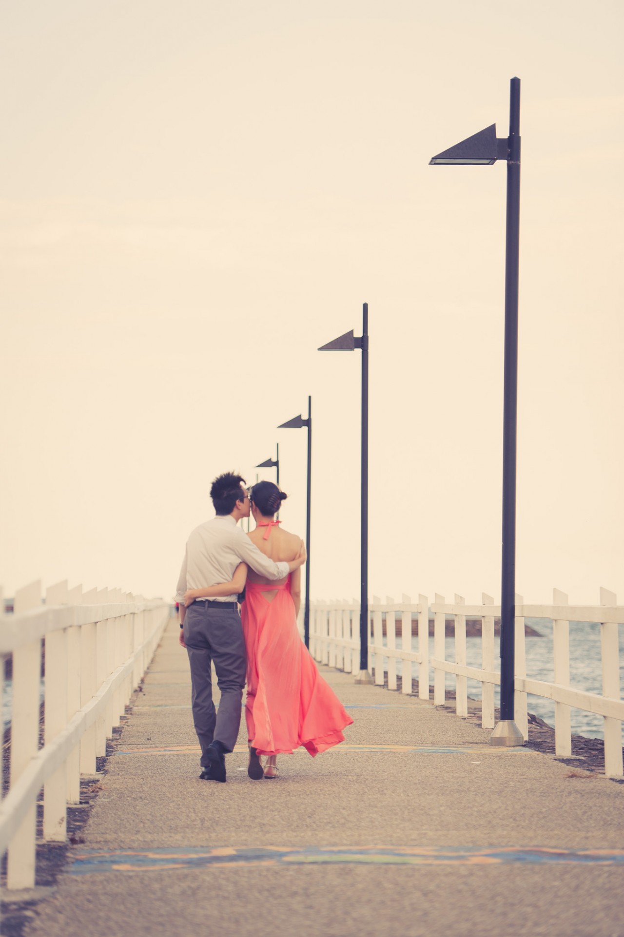 Wynnum Esplanade Portraits - Engagement Photos by MinWye Studios - Tish and Jun walking down a pier