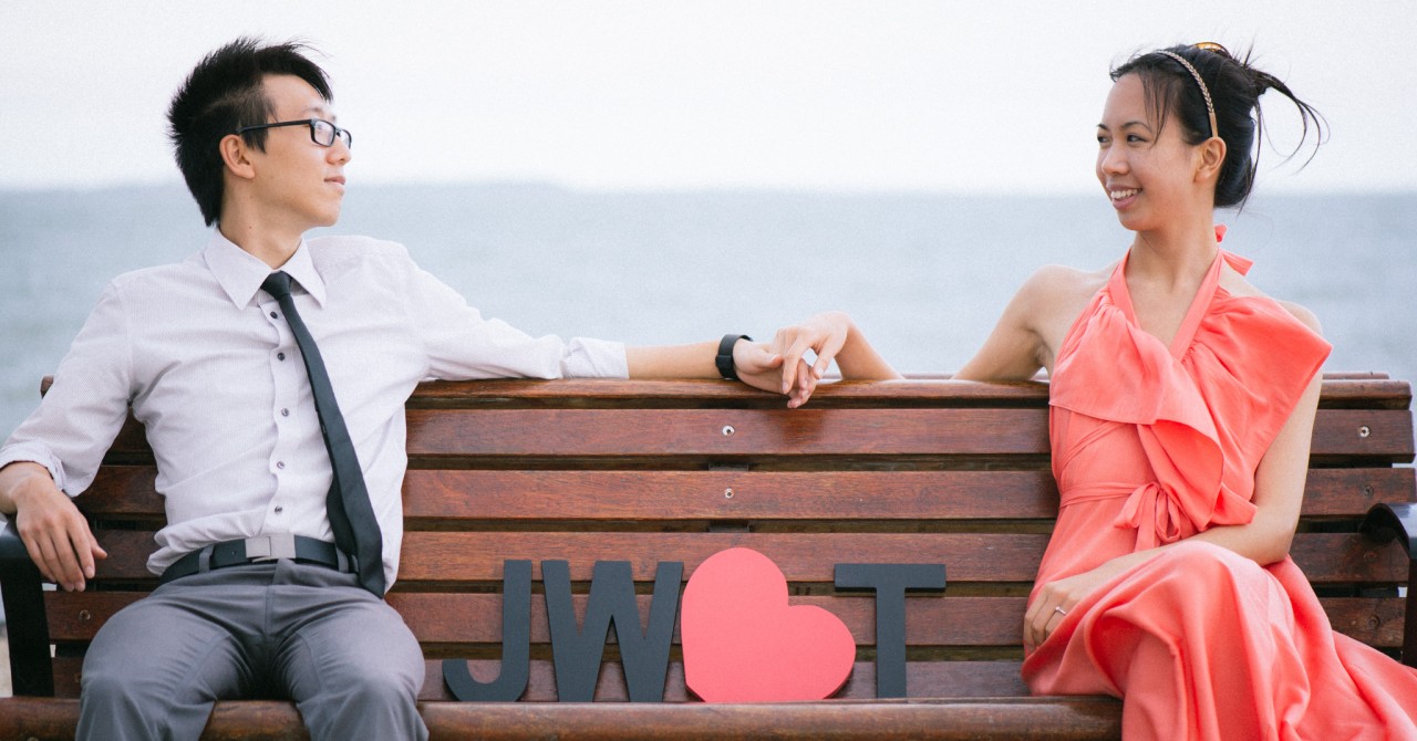 Wynnum Esplanade Portraits - Engagement Photos by MinWye Studios - Jun and Tish's back, looking at each other on a bench