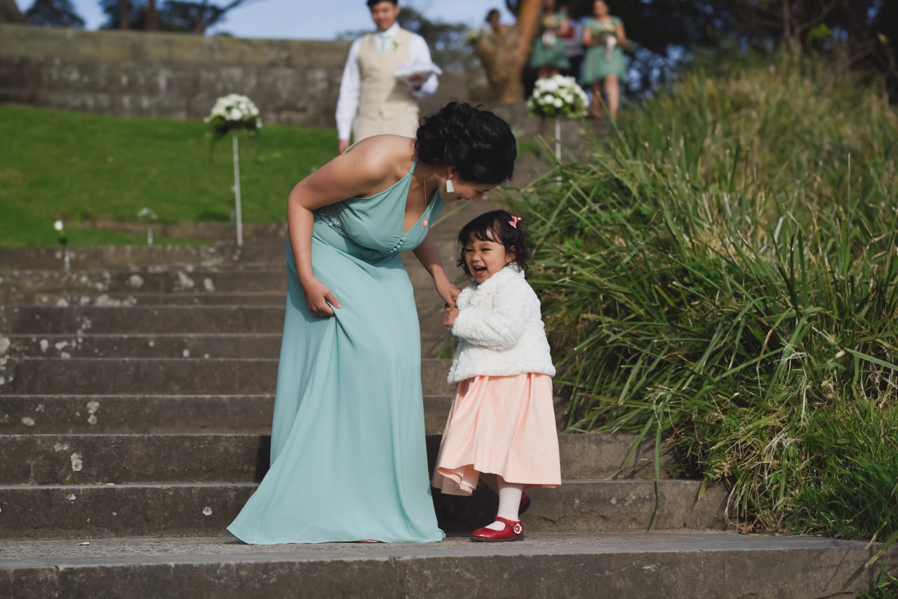 Bridesmaids and flower girls walking down the aisle steps