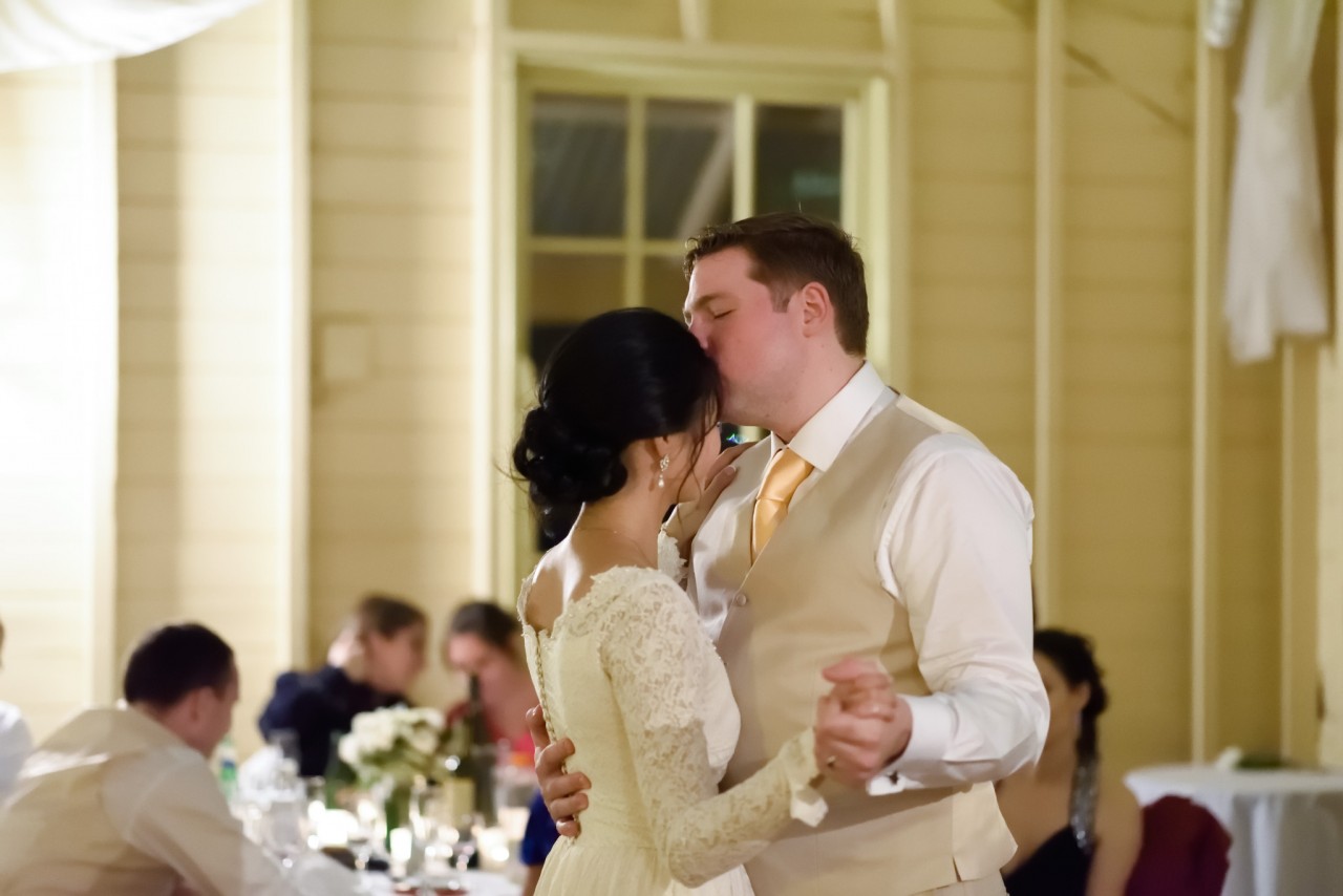 Groom kissing his bride during their first dance