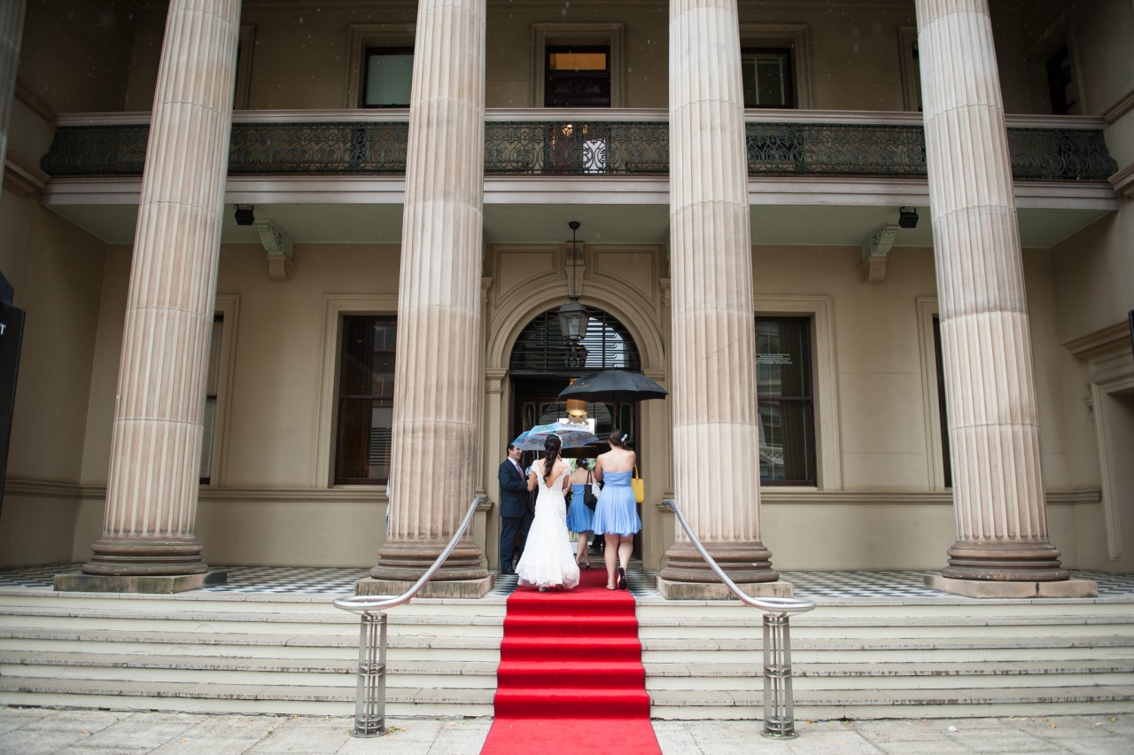 Bridal party entering Brisbane Customs House on a rainy day