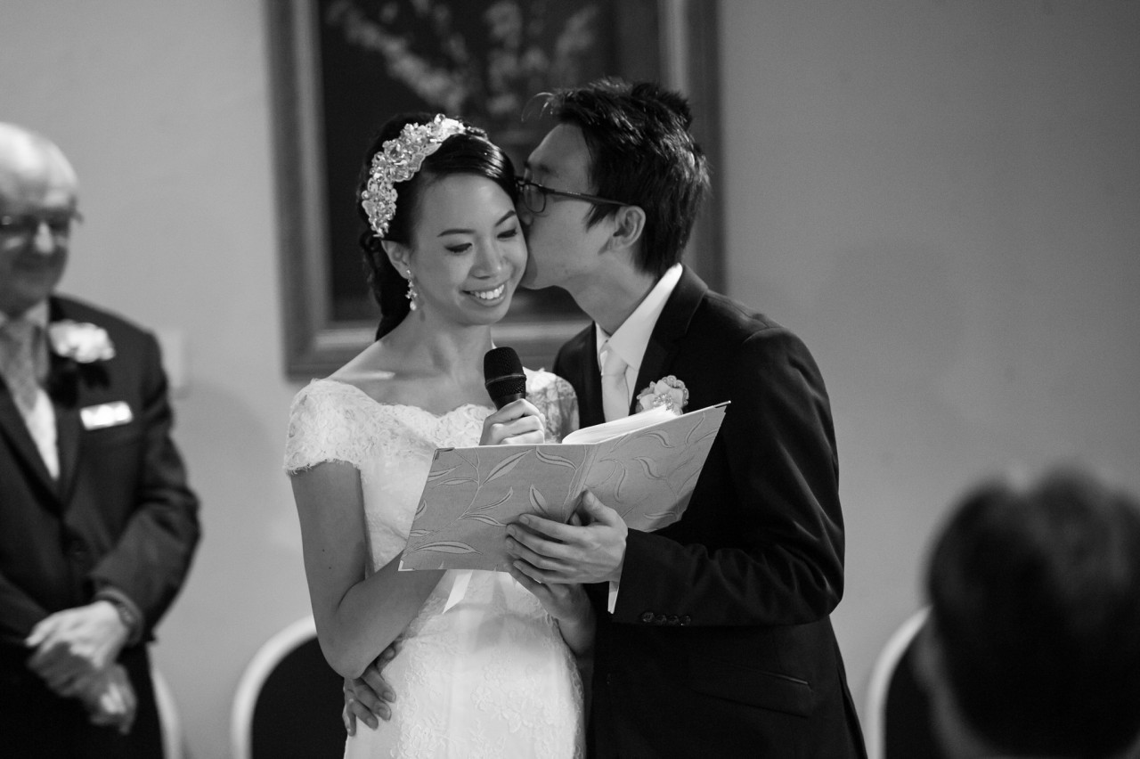 Jun giving Tish a kiss as she finishes reading her vows on their wedding day at Brisbane Customs House