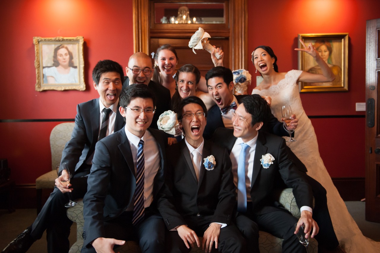 Groomsmen giving their best faces as the bridesmaids photobomb their photo
