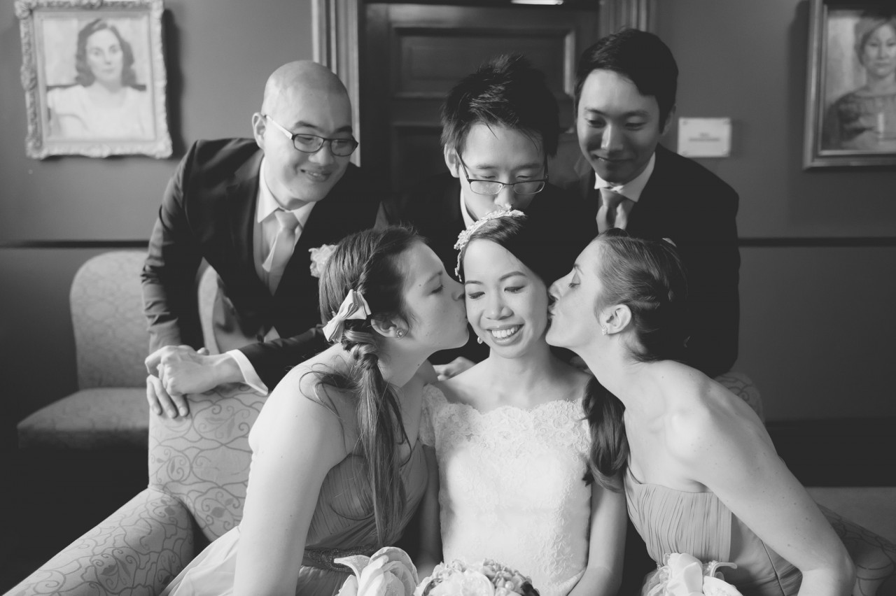 Jun joining in the love as Tish's bridesmaids gives her a kiss on the cheeks