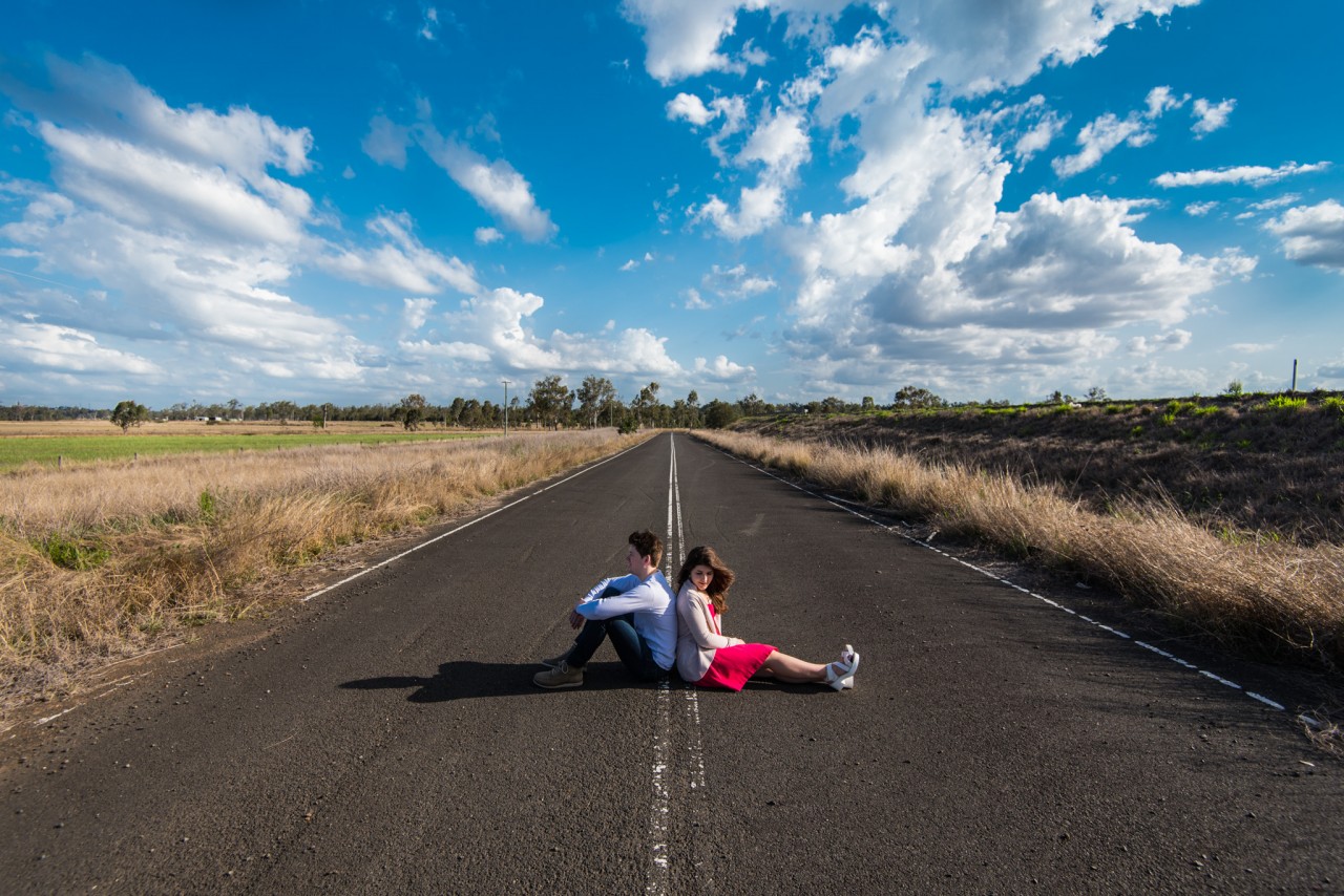 Brendan and Talitha sitting on an abandoned road