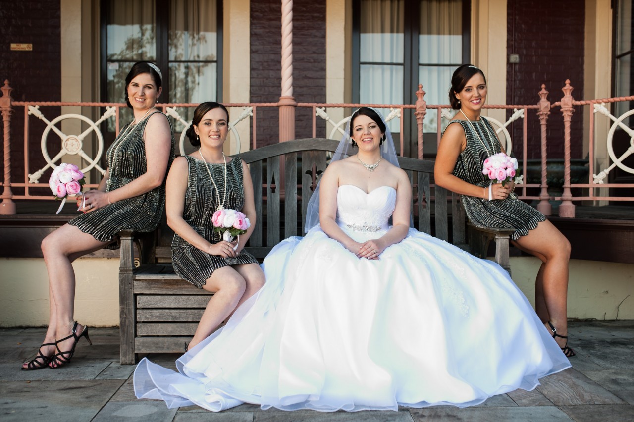 The bridesmaids sitting on a bench at Shafston House, Kangaroo Point