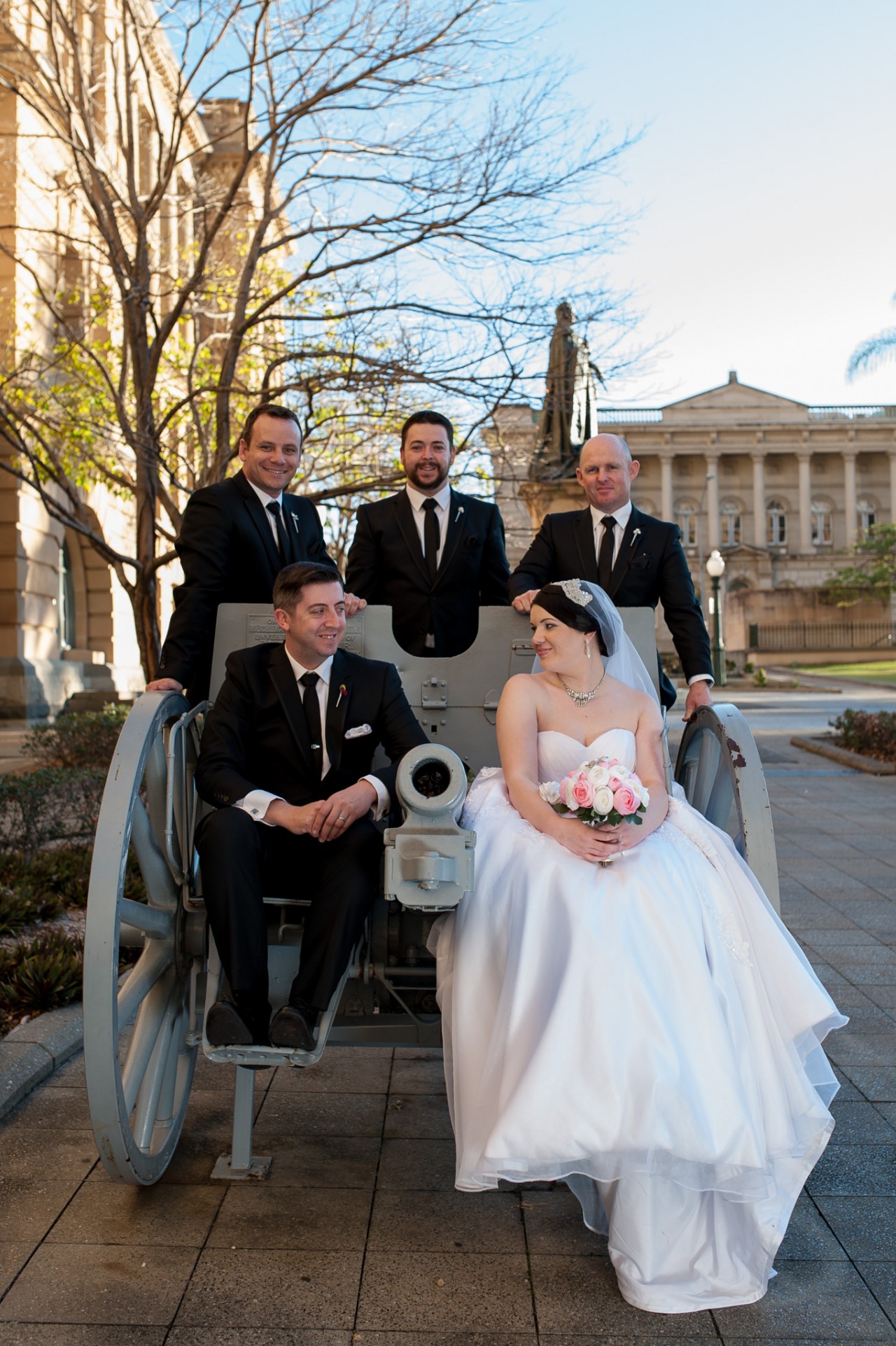 The bridal party sitting on a cannon at the Brisbane Treasury Casino