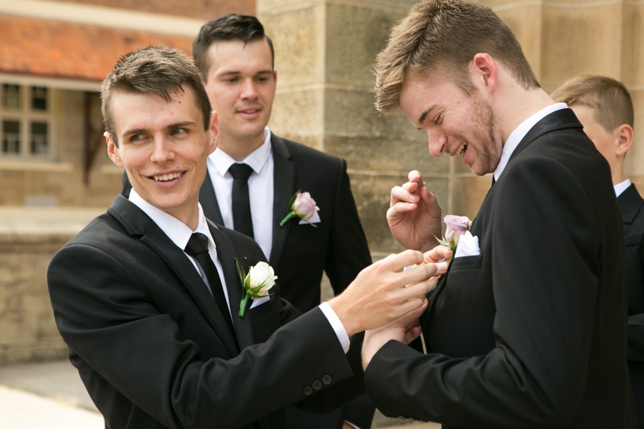 Nic helping David with his corsage