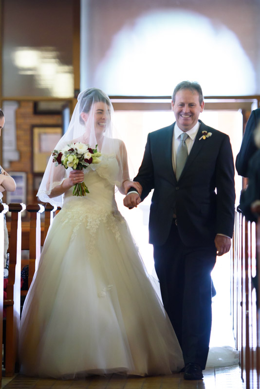 Brian walking her daughter down the aisle at St Brigid's Church, Red Hill