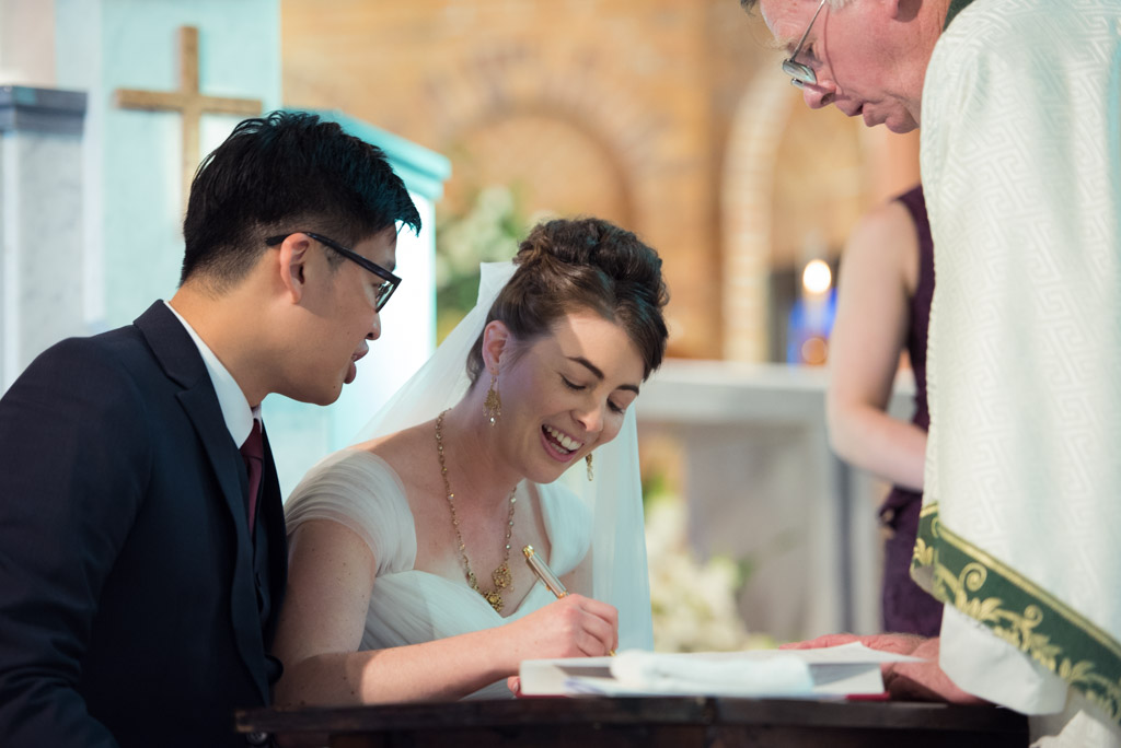 Shawn and Michaela signing the registry during their ceremony