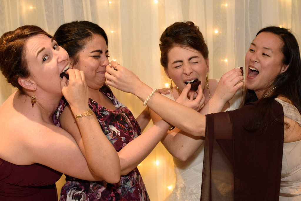 Friends of the bride sharing some cake with each other