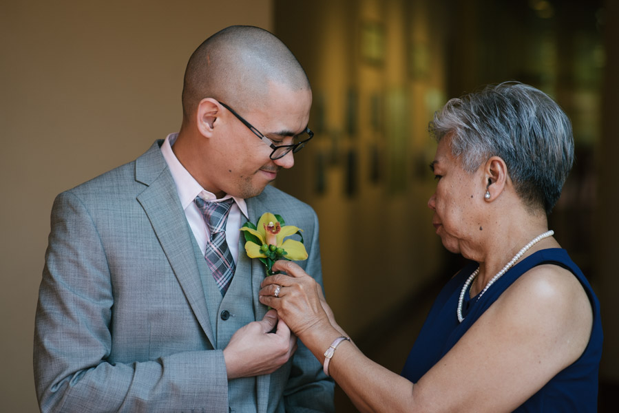 Mother of the groom pinning his corsage
