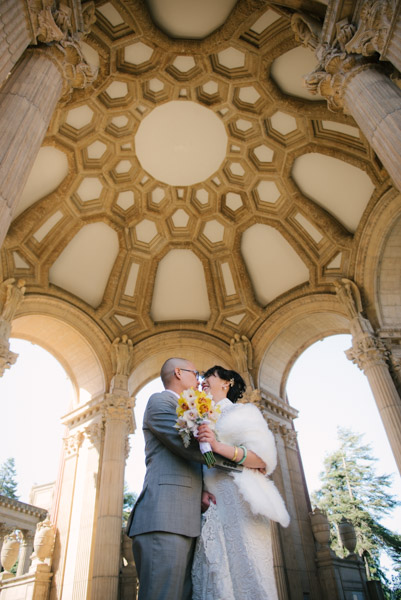 Bride and groom under the Palace of Fine Arts dome