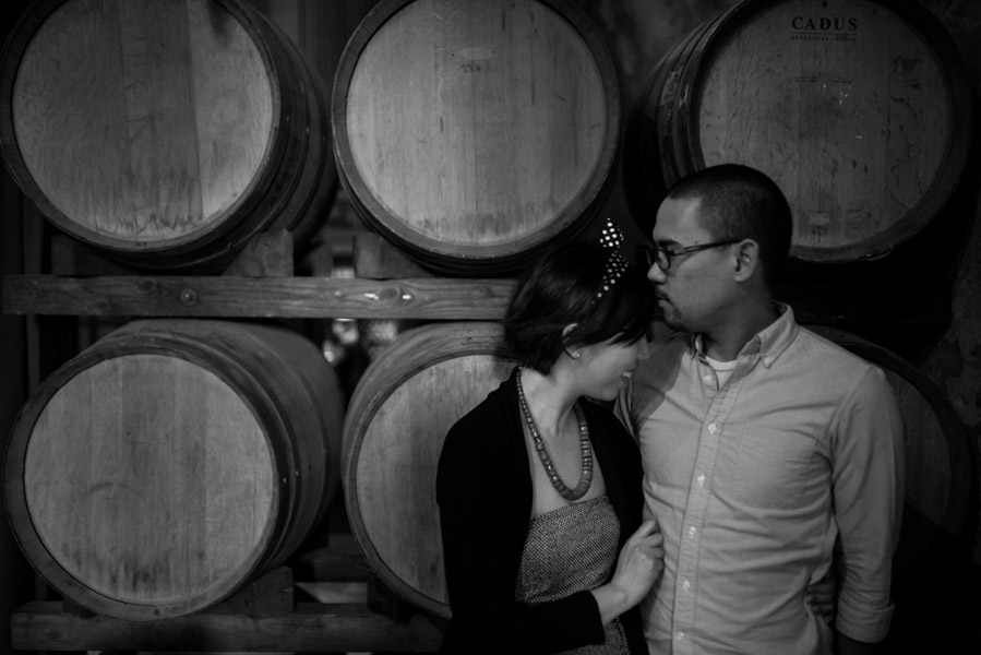 Maurice kissing Maggie on the forehead with barrels in the background