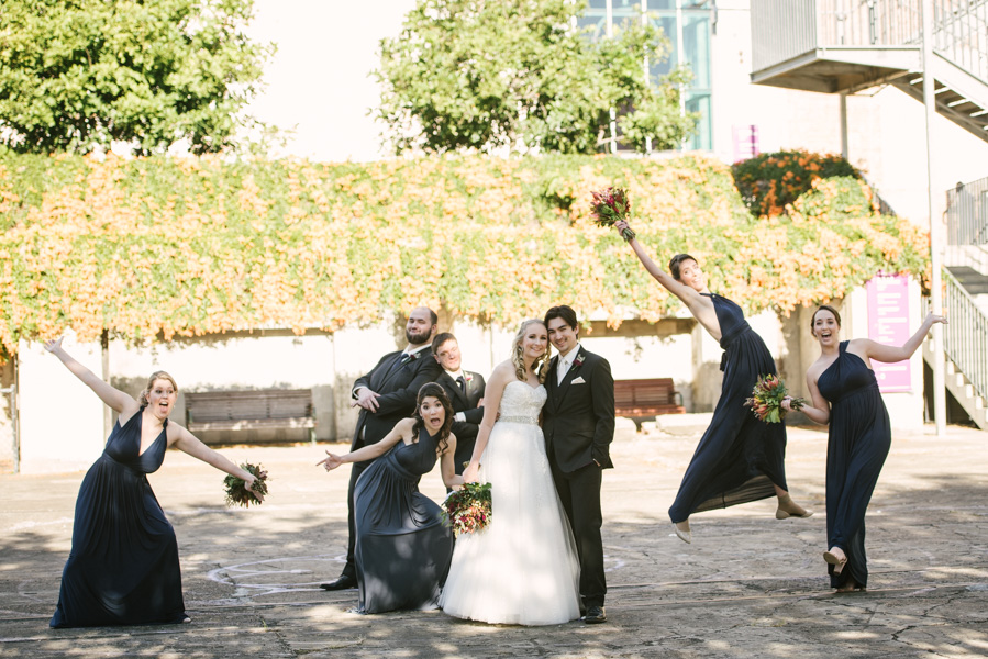 Bridal party photobombing the bride and groom in front of Brisbane Powerhouse