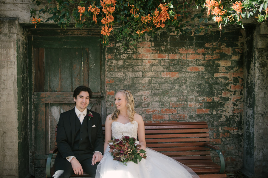 Bride and groom sitting on a bench at Brisbane Powerhouse