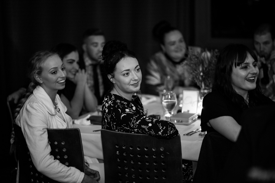 Black and white of guests looking on